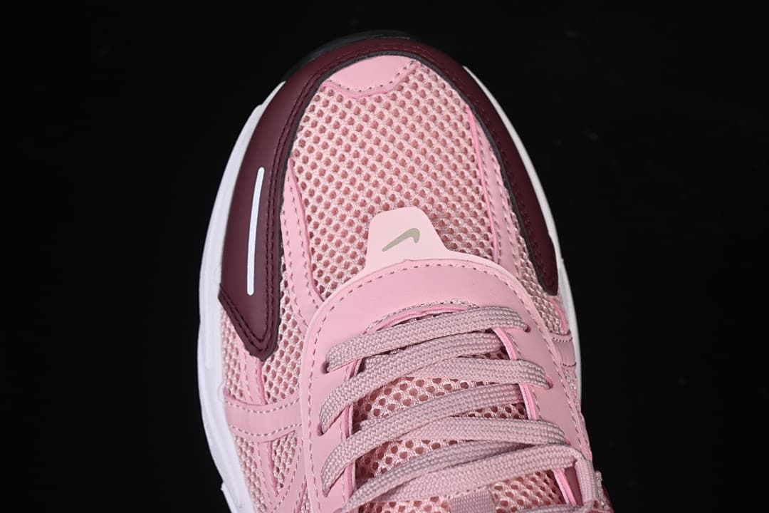 Top-front view of the pink sneaker with burgundy toe accents