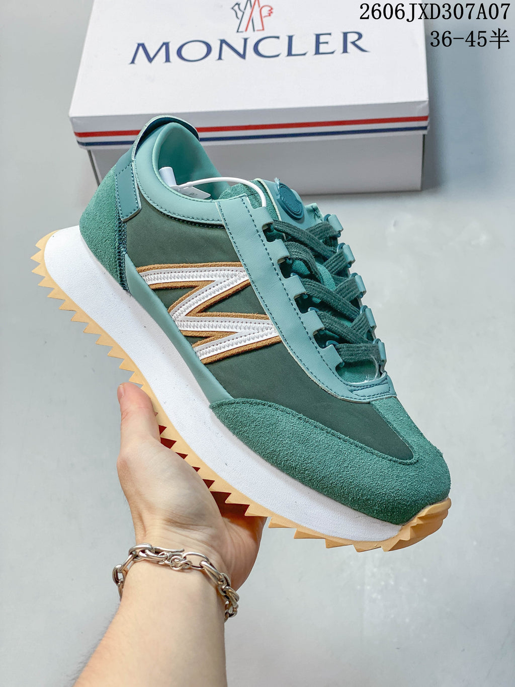 Side view of a teal sneaker showing layered panels, side accents and a textured outsole