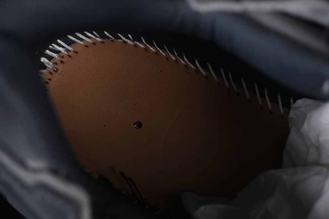 Close-up inside the sneaker showing the footbed and interior stitching