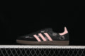 Side view of black Samba OG sneakers with pink stripes and character graphics