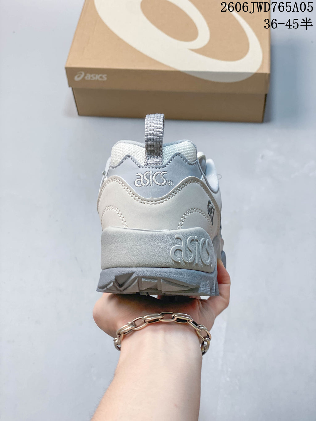 Rear view of a light white and grey ASICS Gel-TRUCK sneaker