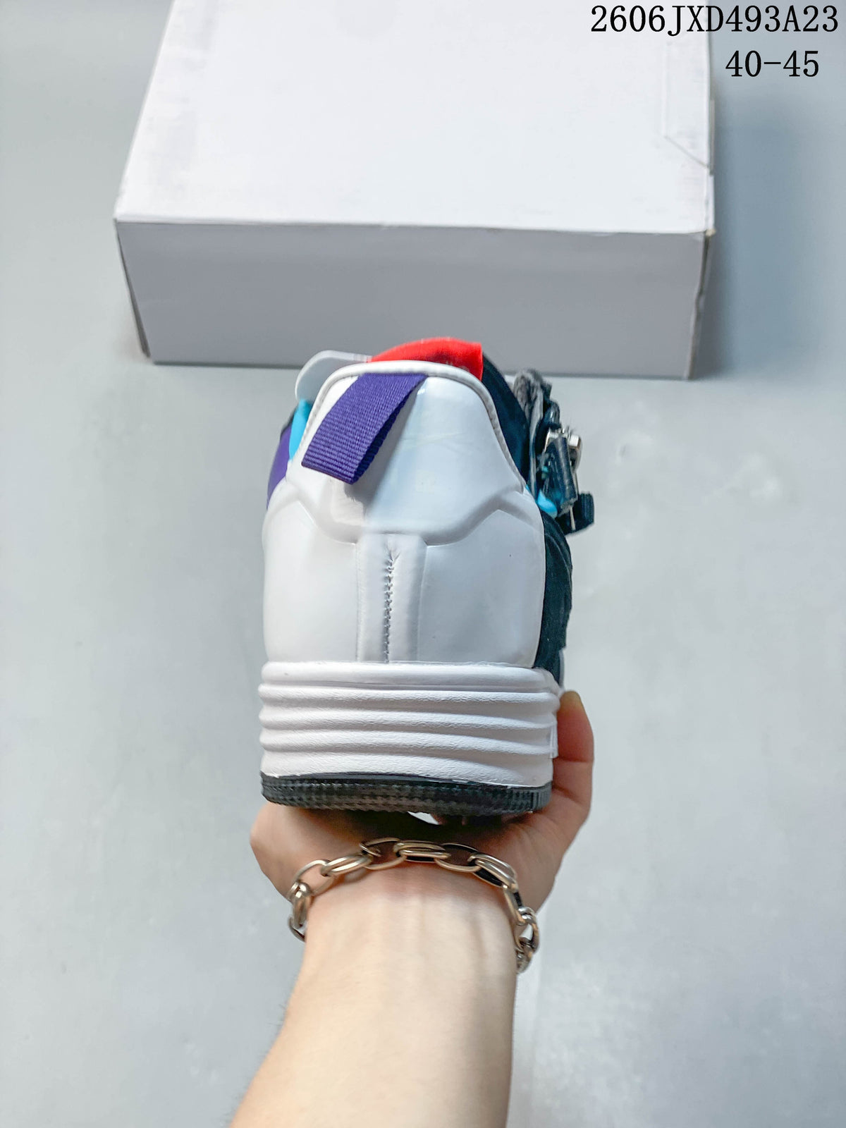 Rear view of the sneaker showing the white heel and colored pull tabs