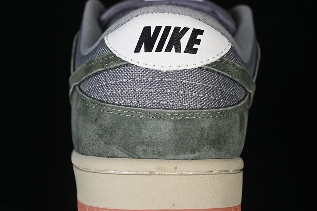 Rear view showing grey collar panels, olive-green overlays and white heel tab