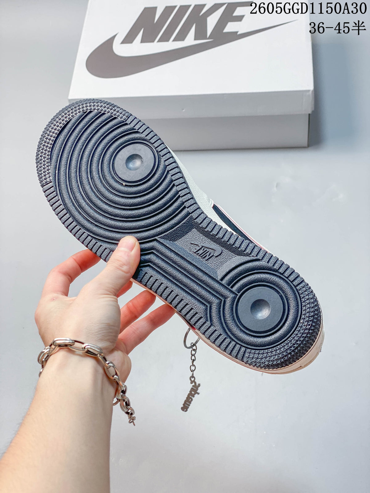 Dark outsole of the cream, navy and red low-top sneaker