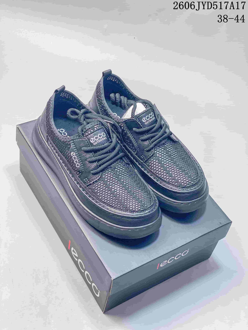 Pair of dark gray ECCO lace-up sneakers displayed on a box; image text states sizes 38–44.