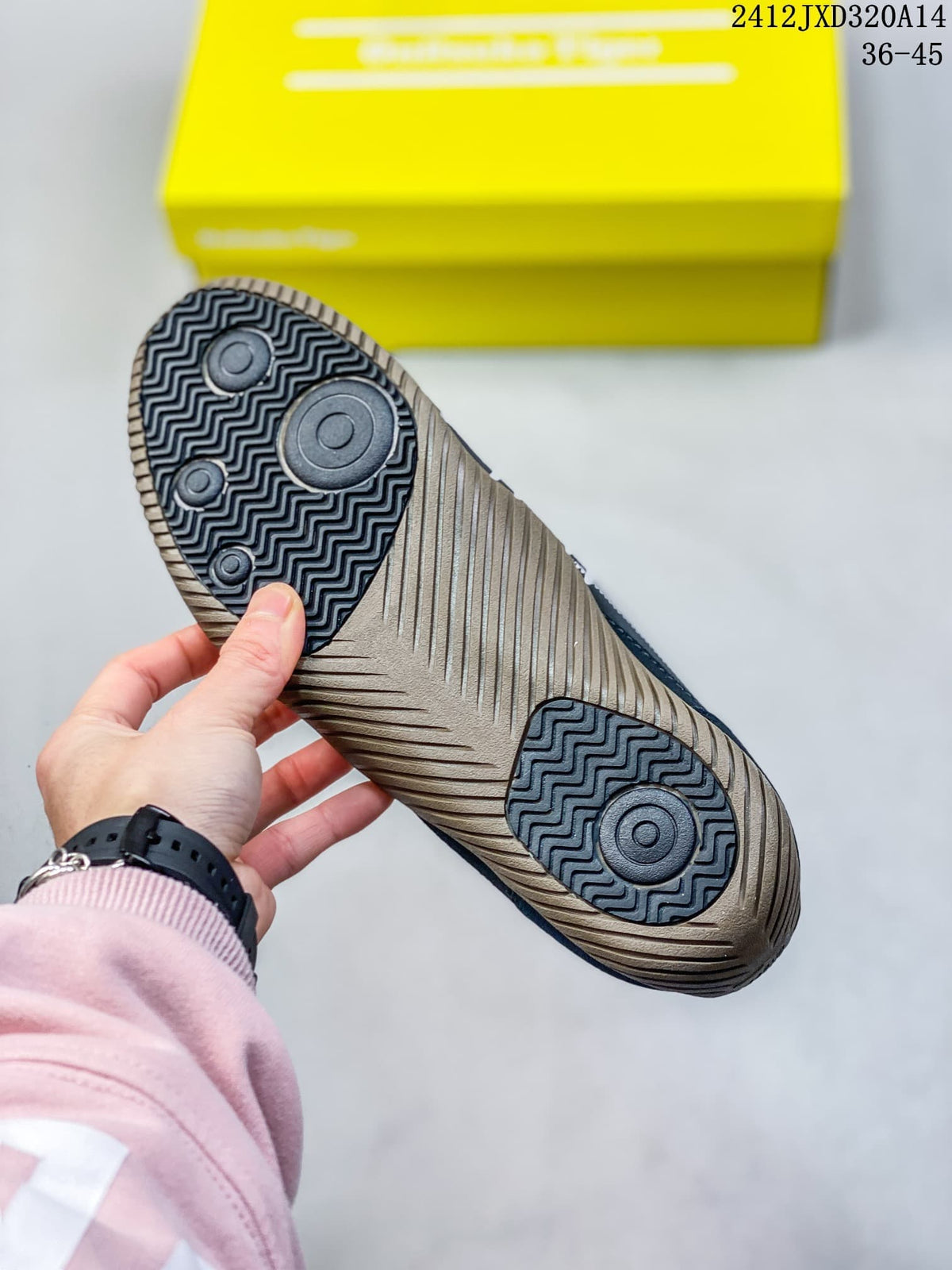Close-up of the patterned outsole on a navy SCLAW sneaker.