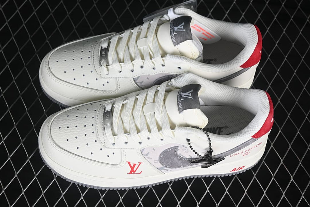 Pair of off-white low-top sneakers with gray patterned panels, gray Swooshes, and red accents