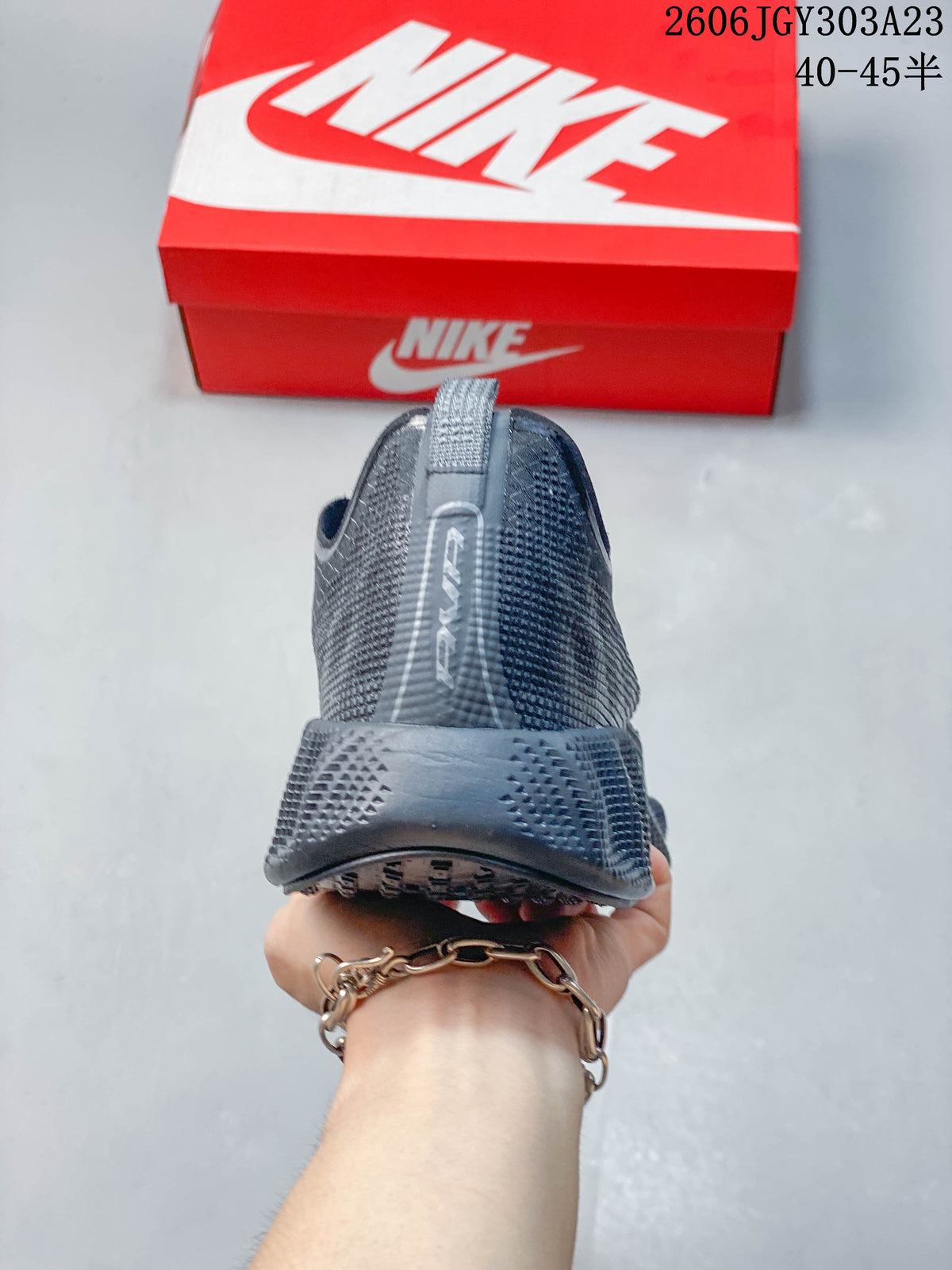 Rear view showing the heel and pull tab of a dark Nike Ava Rover shoe