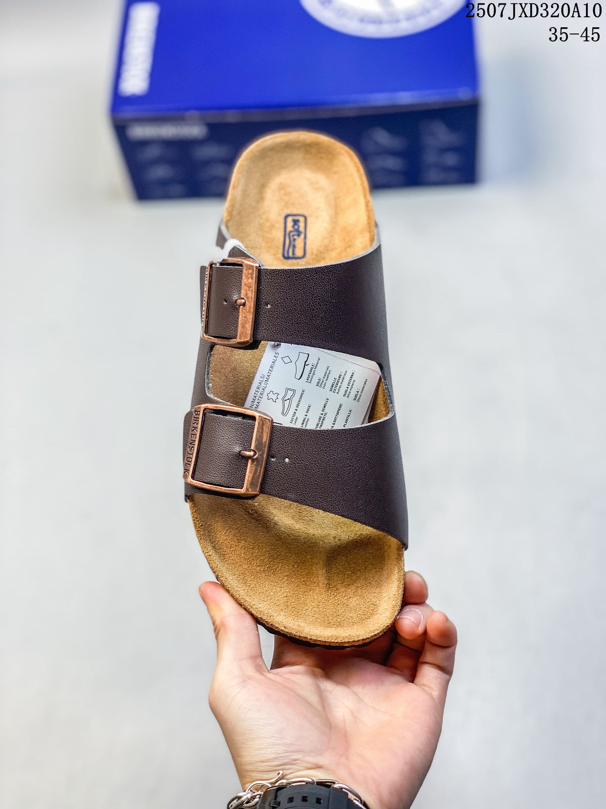 Top view of a dark brown two-strap slide sandal with bronze-tone buckles and a contoured footbed.