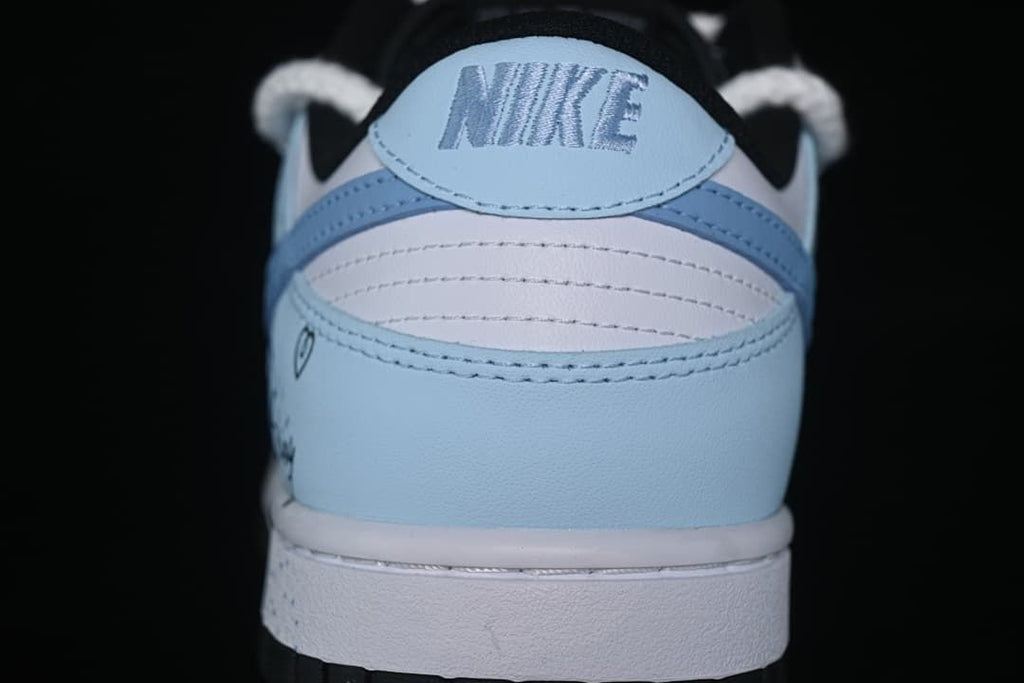 Rear view of a white and light-blue low-top sneaker