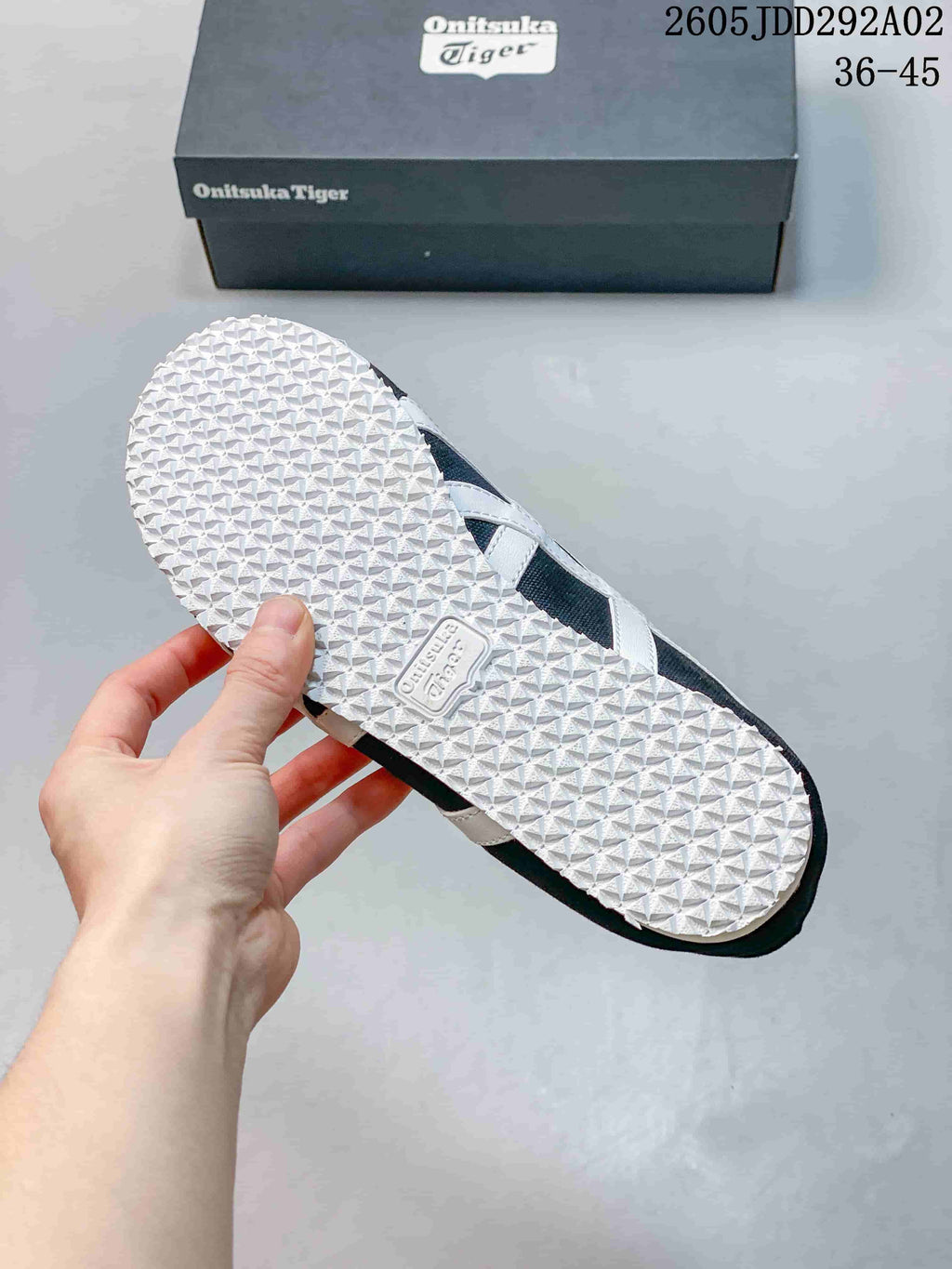 Textured white outsole of a charcoal Onitsuka Tiger sneaker