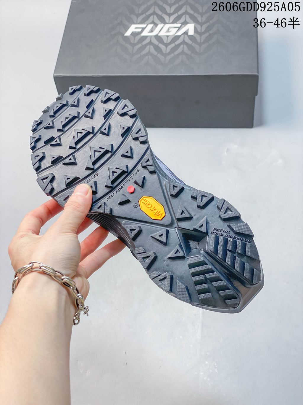 Lugged outsole shown beside the FUGA shoe box