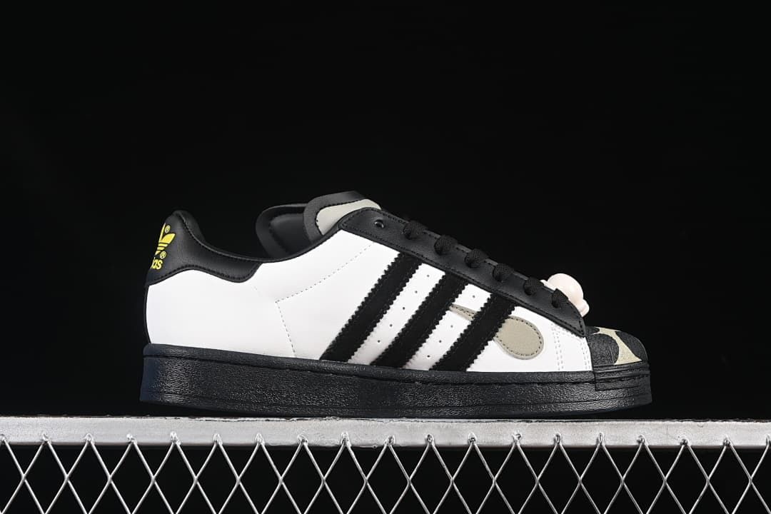 Side profile showing the white upper, black stripes, and black sole