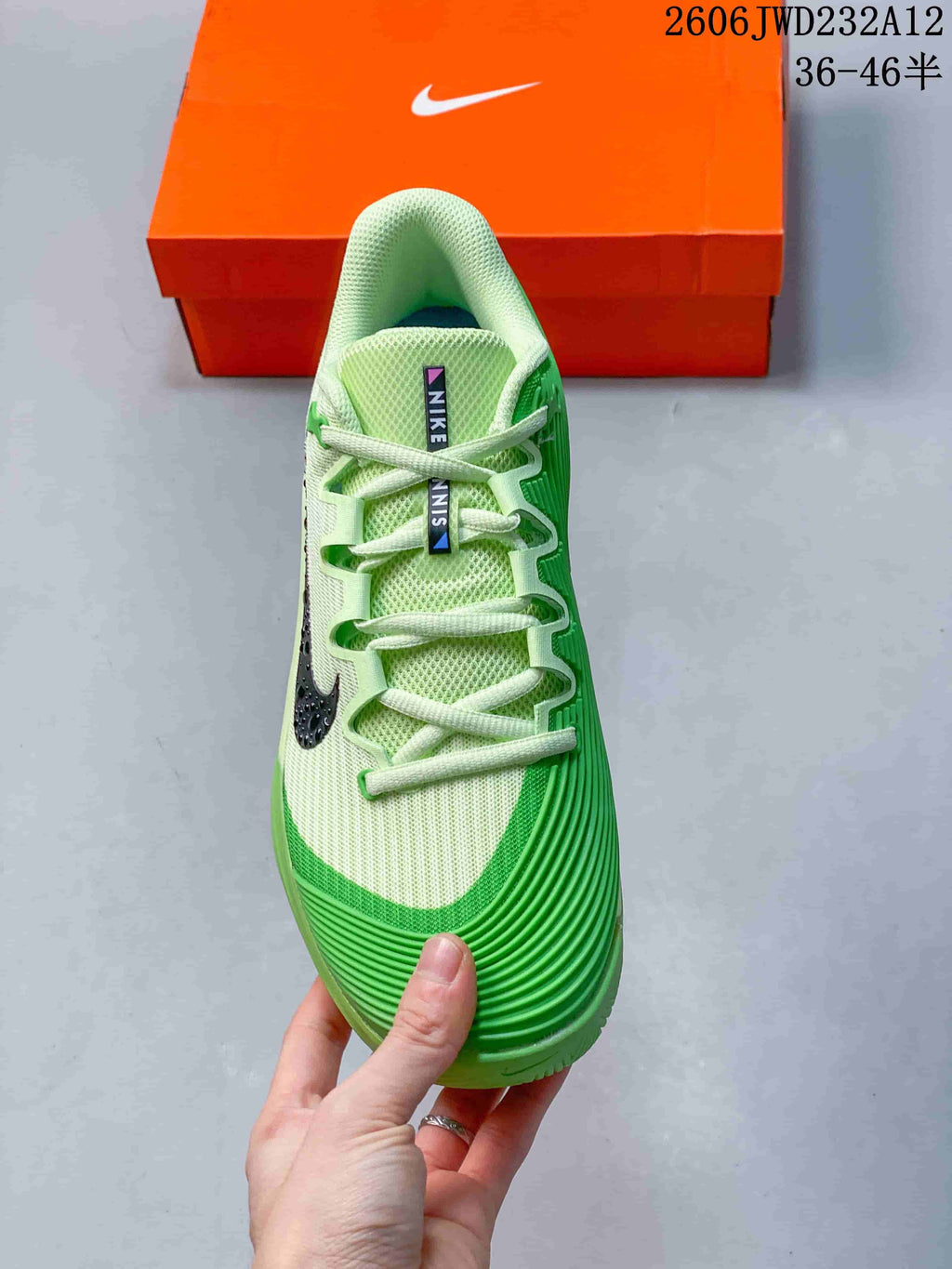 Top view showing the laces, mesh-look upper and green toe detailing