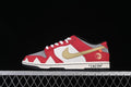 Side view of a red, white, gray, and gold Nike SB Dunk Low with dinosaur-themed details and “JASON” text on the midsole.