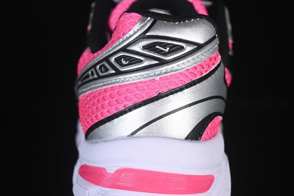 Close-up of the pink mesh-style upper, silver heel panel, and pink heel detail.