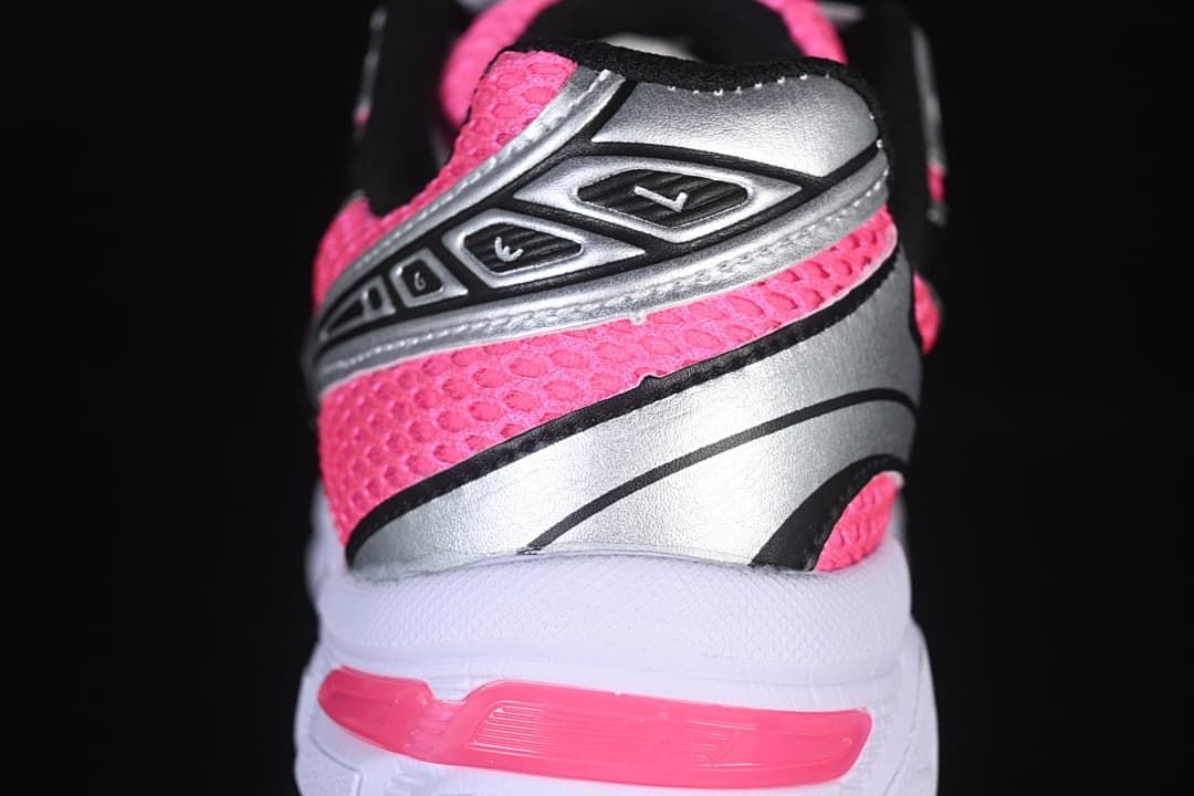 Close-up of the pink mesh-style upper, silver heel panel, and pink heel detail.