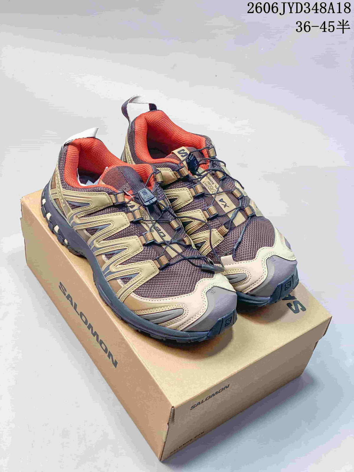 Tan, brown, and orange Salomon XT-3D trail shoes displayed on a box.