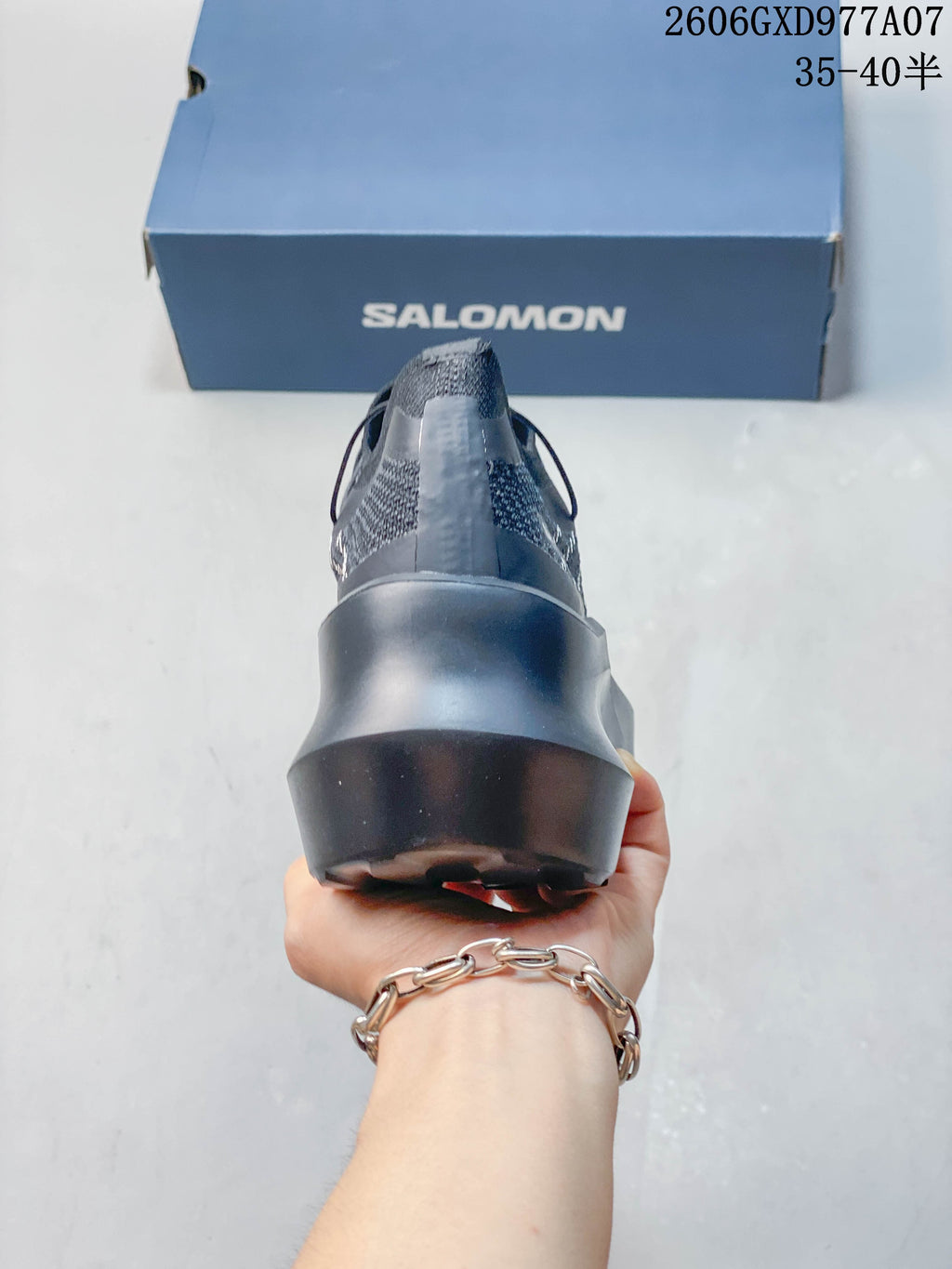 Rear view of the gray sneaker showing its raised platform heel.