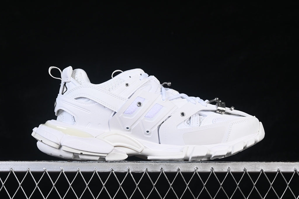 Side profile of the white sneaker with layered panels and a chunky outsole.