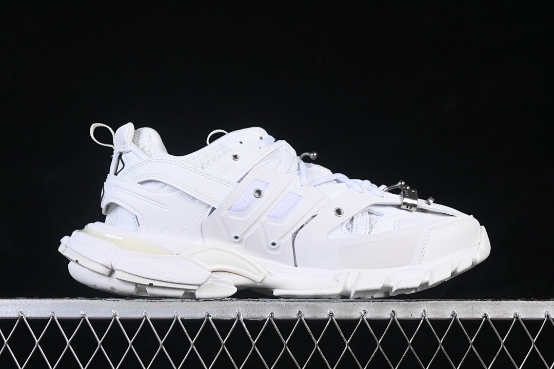 Side profile of the white sneaker with layered panels and a chunky outsole.