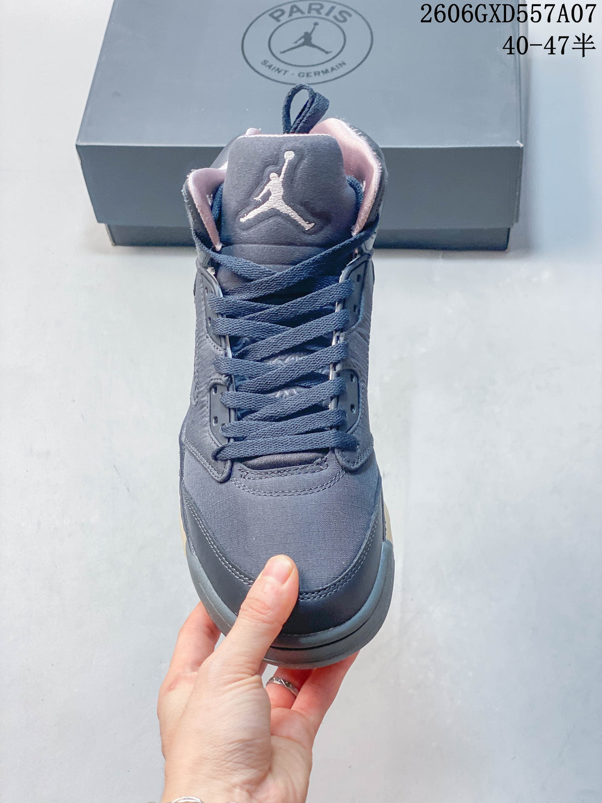 Front view of a gray Jordan Air Jordan 5 high-top sneaker with navy laces and Jumpman tongue logo.
