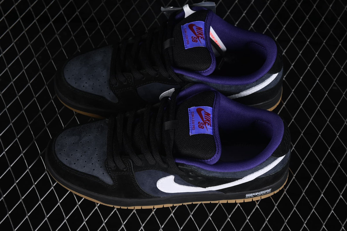 Top-down view of a pair of Nike SB Dunk Low sneakers with purple collars and white side Swooshes.