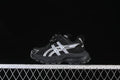Black kids' ASICS sneaker with silver side details, shown in profile.