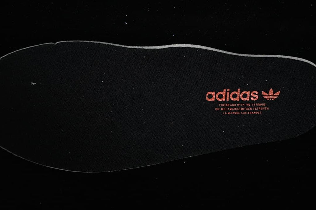 Black Adidas insole with Trefoil branding
