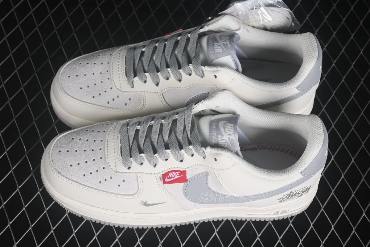 Pair of white and gray low-top sneakers shown from an angled side view.