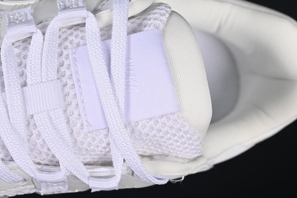 Close-up of the laces and mesh tongue on the white sneaker