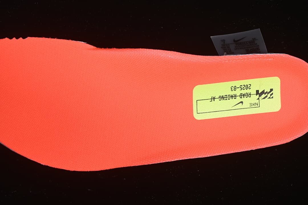 Bright coral shoe insert with a Nike road racing label
