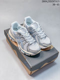 Pair of silver-blue and white ASICS Gel-Kayano 12.1 sneakers displayed on a shoebox