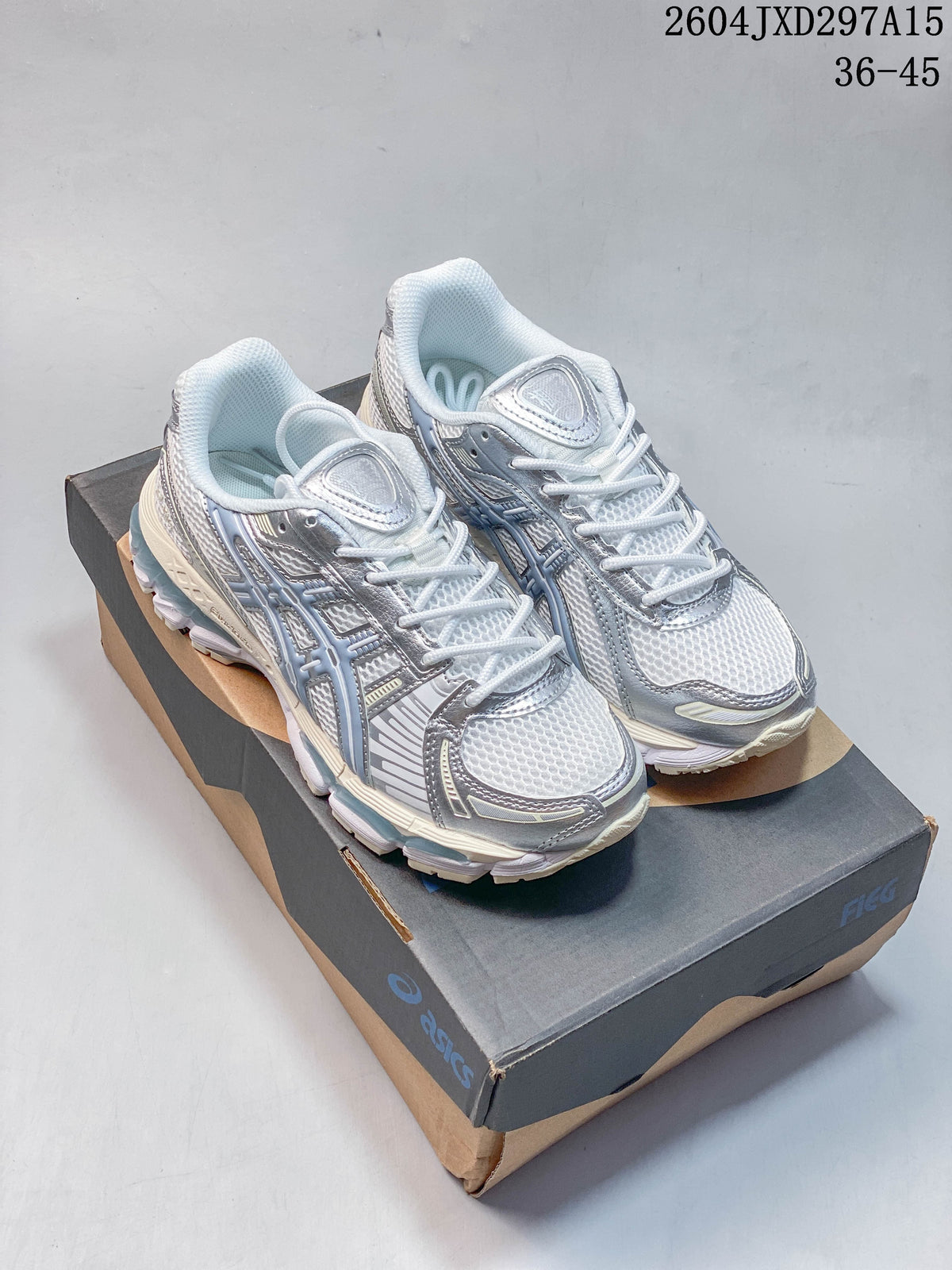 Pair of silver-blue and white ASICS Gel-Kayano 12.1 sneakers displayed on a shoebox