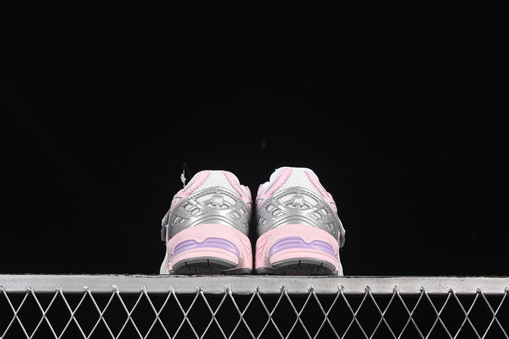 Rear view of the pair showing silver heel panels and pink soles.