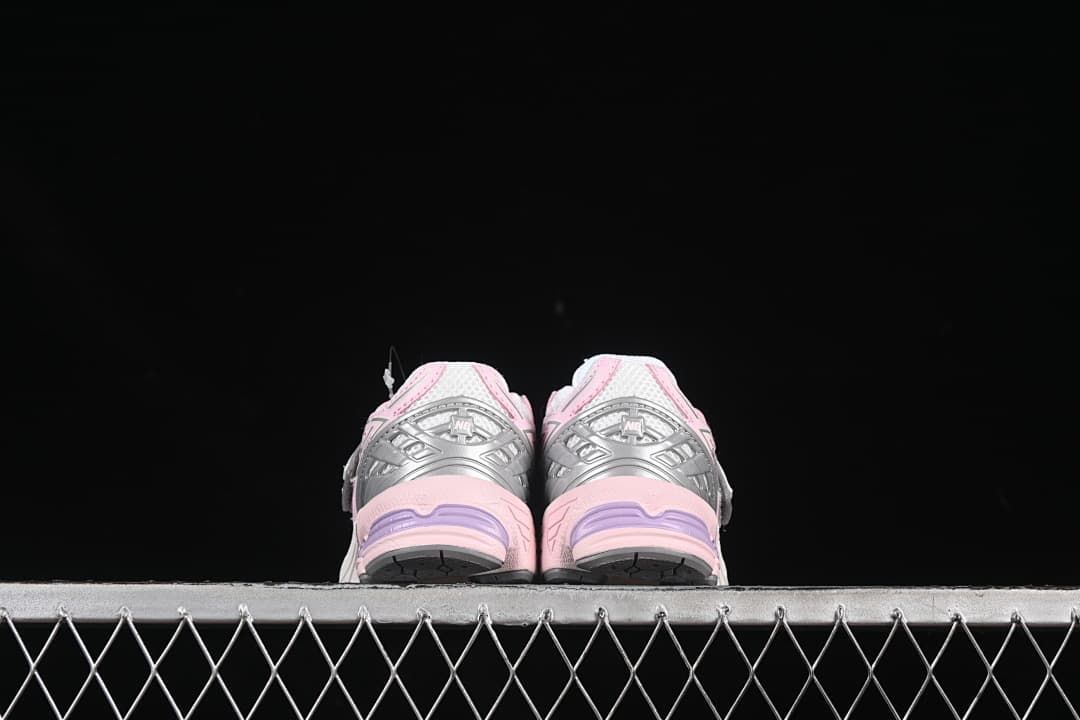 Rear view of the pair showing silver heel panels and pink soles.