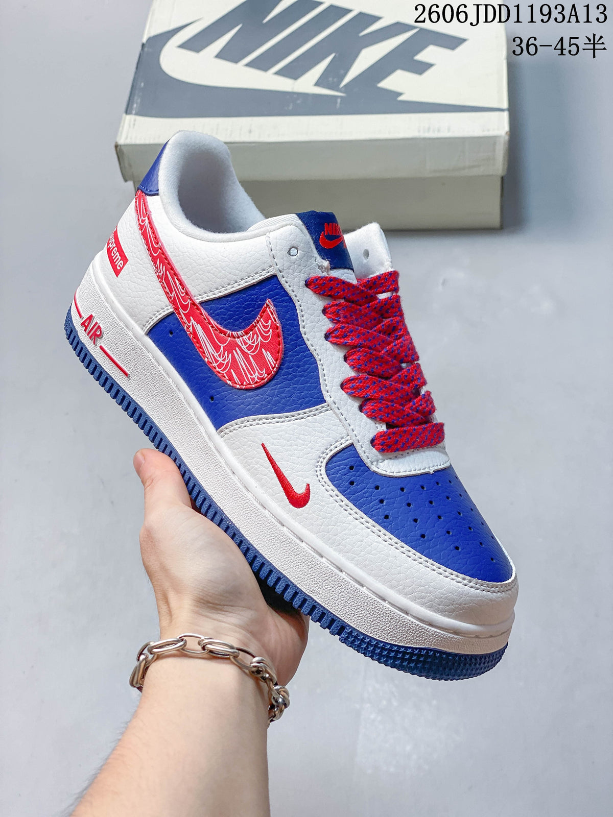 Angled view of the white, blue, and red sneaker with patterned laces