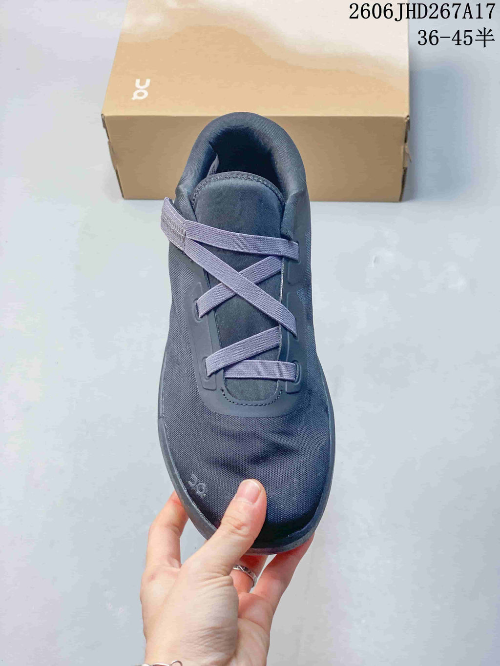 Top view of a slate-blue sneaker showing its elastic cross-lacing.