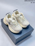 Pair of ivory-toned SMFK Future Ripple low-top sneakers with black accents and pale yellow details, shown from above.