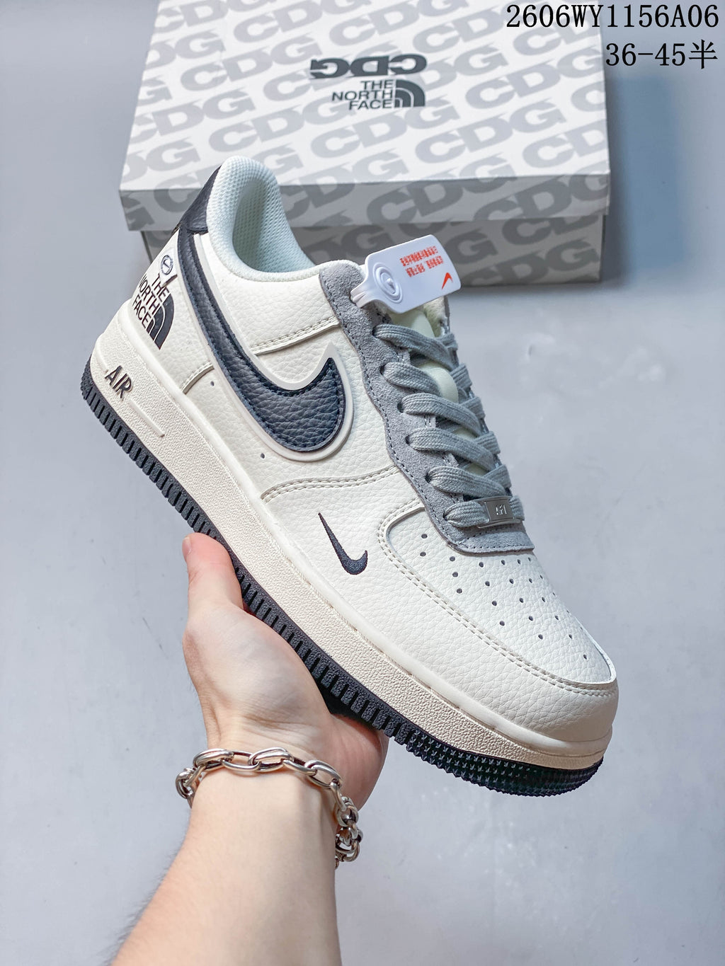Angled close-up of an off-white Nike Air Force 1 '07 Low sneaker with gray laces and navy accents.
