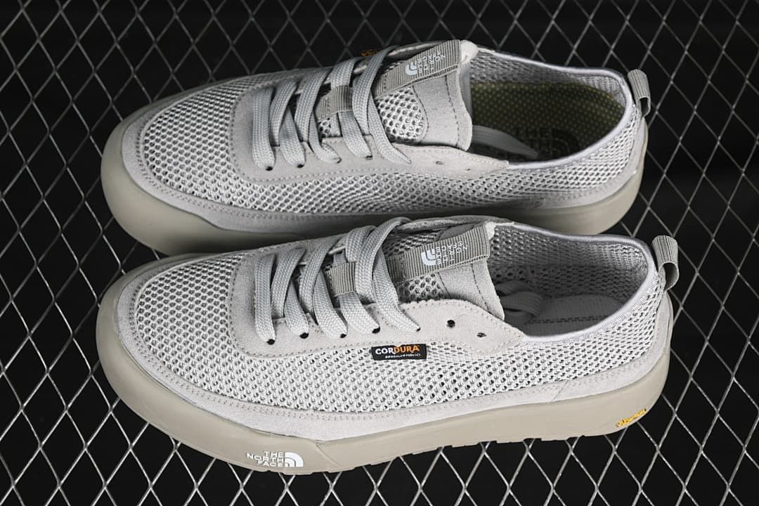 Pair of grey low-top sneakers shown from above and the side.