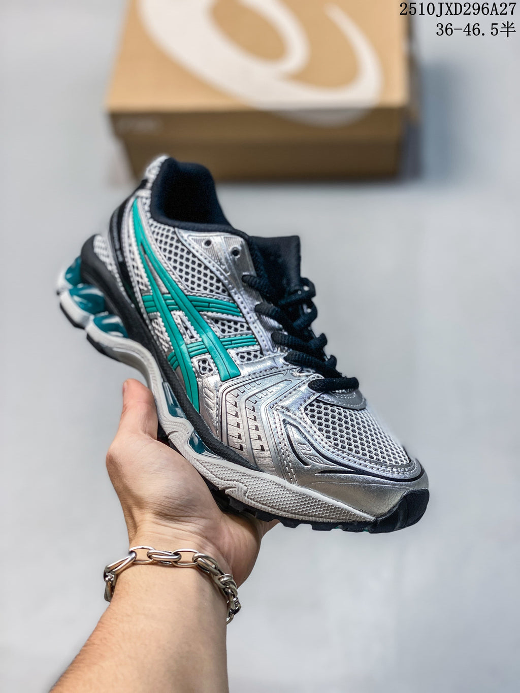 Silver mesh sneaker with teal accents and a dark sole, held in hand.