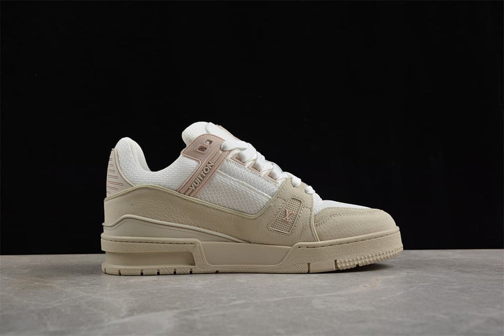 Side view of the beige and white sneaker against a black background.