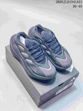 Pair of grey and navy Adidas Hyperboost sneakers displayed on a shoebox.