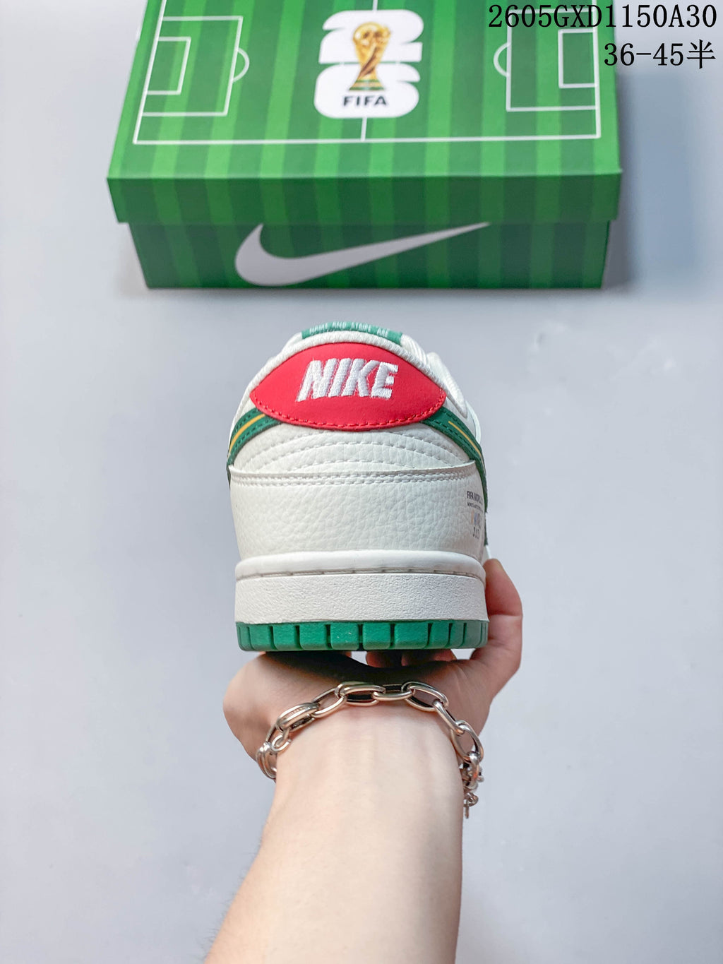 Rear view of the sneaker showing a red Nike heel tab and green outsole.