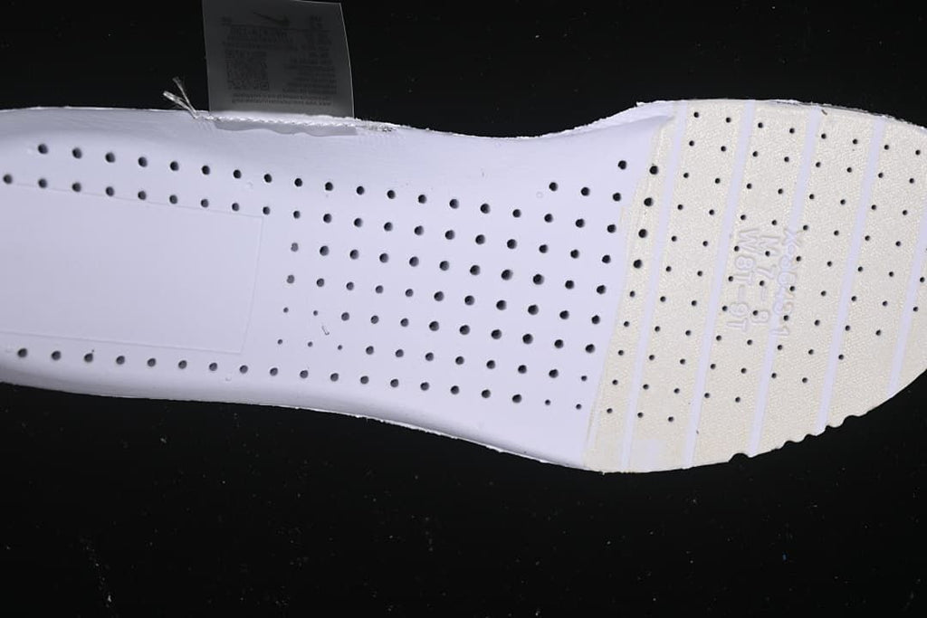 Underside view of the shoe showing a white perforated insole.