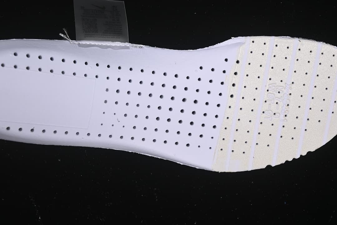 Underside view of the shoe showing a white perforated insole.