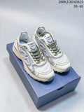 Pair of gray and light-colored Dior B30 low-top sneakers with olive-toned laces, shown on a blue box