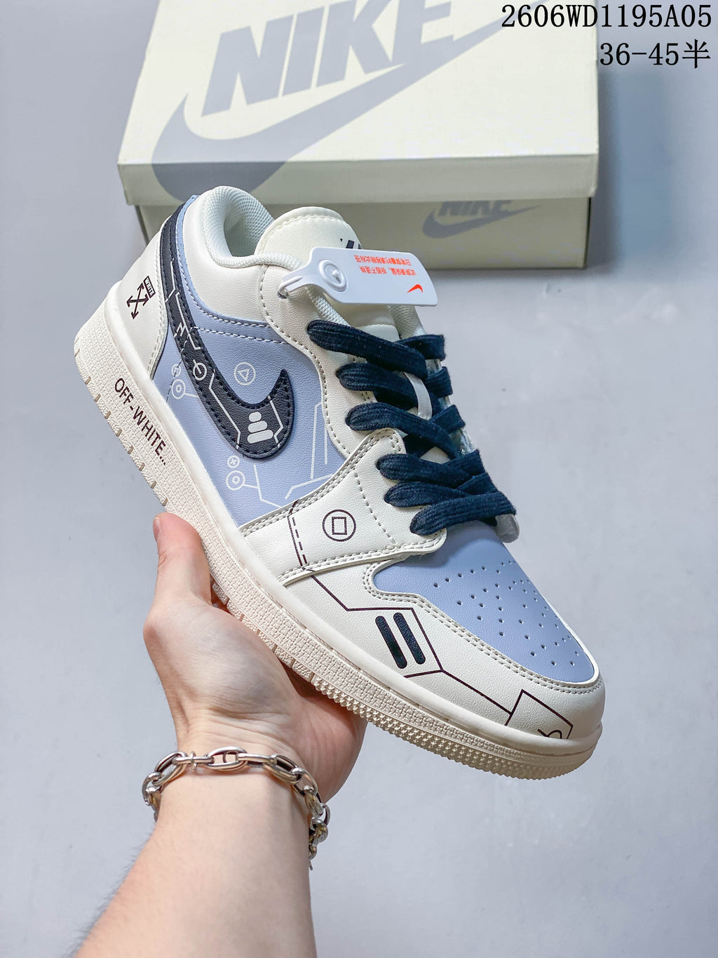 Angled side view of a white and pale blue sneaker with dark navy laces