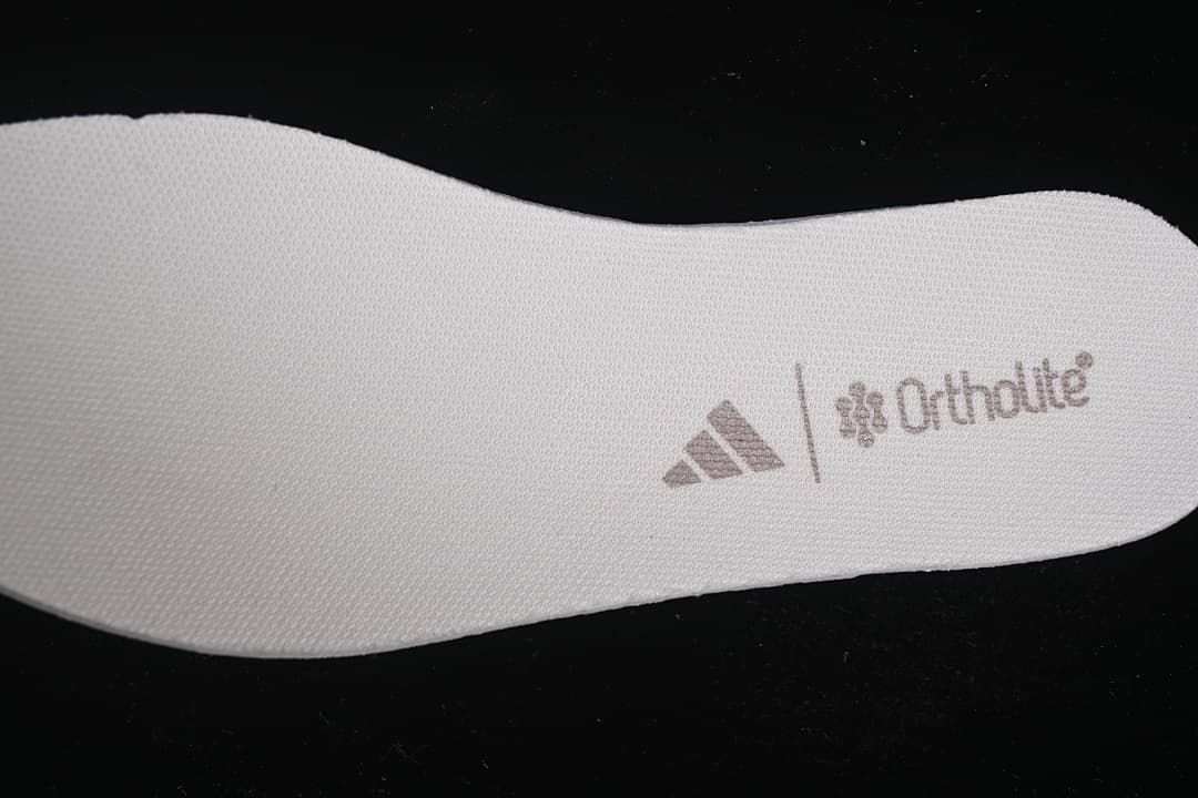 Close-up of a textured insole with a visible logo.
